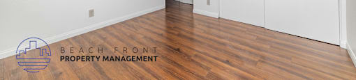 A room with a logo of Beach Front Property Management on the floor.