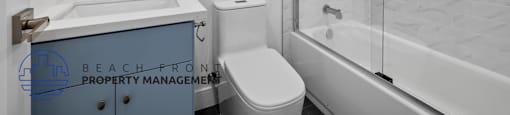 A bathroom with a white sink, toilet, and bathtub.