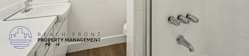 A white bathroom with a shower and sink.