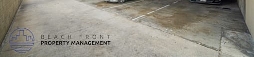 A parking garage with three cars parked inside and a logo for Beach Front Property Management in the corner.