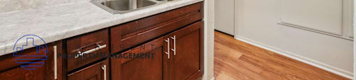 A kitchen with a sink and cabinets.
