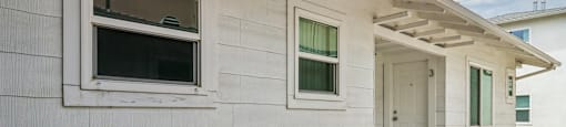 A white house with a door and windows.