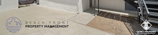 a beach front property management home with stairs and a driveway