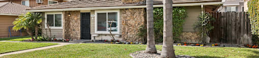 A house with a palm tree in front of it.