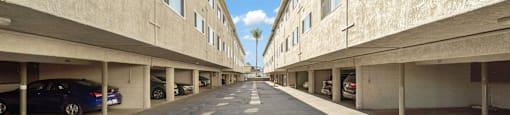 A long, empty parking garage with a logo for Beach Front Property Management in the bottom left corner.