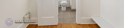 A white bathroom with a toilet and sink.