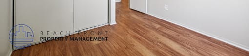 A room with a sliding door and wooden flooring.