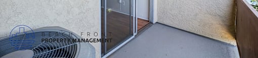 A balcony with a sliding door and a fan.