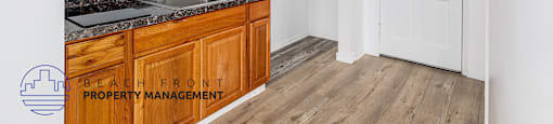 A kitchen with wooden cabinets and a white microwave above the sink.