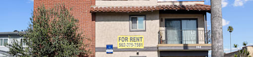 A building with a for rent sign on the front.