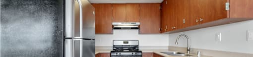 a kitchen with wooden cabinets and stainless steel appliances