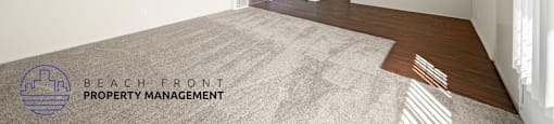 A spacious room with a carpeted floor and a ceiling fan.