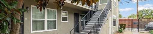 A house with a staircase leading to the front door.