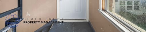 A white door with a black handle is in a room with a window.