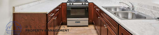 A kitchen with wooden cabinets and a stove top oven.