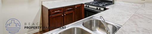 A kitchen with wooden cabinets and a stove top oven.