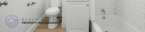 A white bathroom with a toilet, sink, and bathtub.