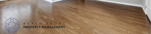 the living room and dining room with wood flooring and a ceiling fan