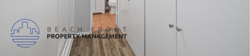 a renovated bathroom with white cabinets and a door to the shower