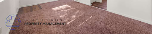 A room with white walls and a carpeted floor.