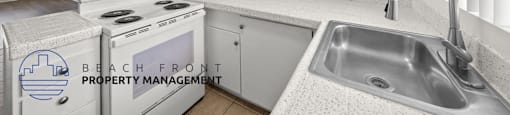 A kitchen with white cabinets and a stove top oven.