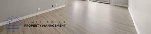 the renovated living room and dining room with wood flooring