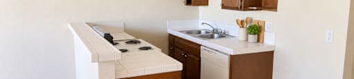 A kitchen with brown cabinets and a white stove top oven.