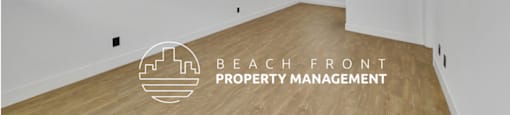 a living room with white walls and wood floors and the beach front property management logo