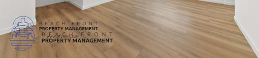 an empty living room with white walls and a wooden floor