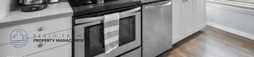 a kitchen with stainless steel appliances and white cabinets