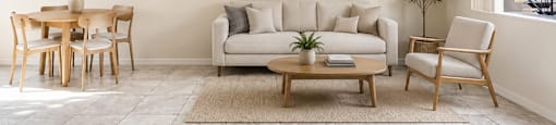 A living room with a couch, chairs, and a coffee table.