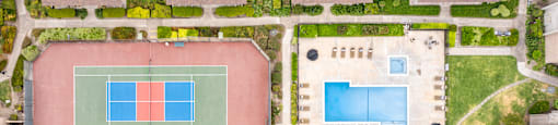 Tennis courts are located in a park-like setting.