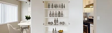 A kitchen with a white cabinet and a dining table.