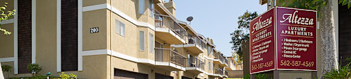 a row of apartments with a sign in front of them