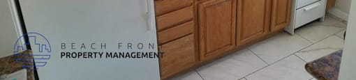 a kitchen with white appliances and wooden cabinets