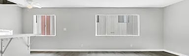 A room with a grey floor and white walls.