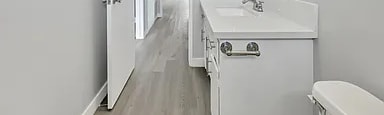 A white bathroom with a sink, toilet, and bathtub.