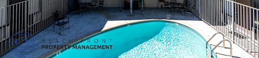 A pool in a courtyard surrounded by apartment buildings.