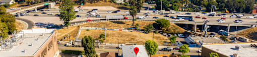 An aerial view of a parking lot with a building that has the words "Beach Property Management" on it.
