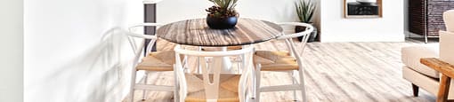 A white room with a round table and chairs.