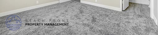 A room with a ceiling fan and a carpeted floor.