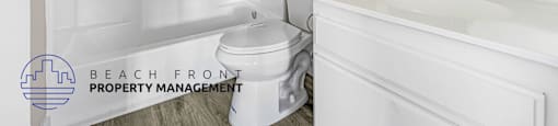 A white bathroom with a toilet, sink, and shower.