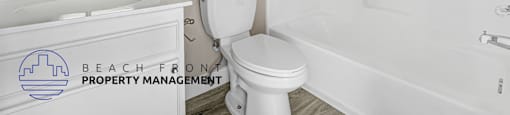 A white toilet sits next to a white sink in a bathroom.