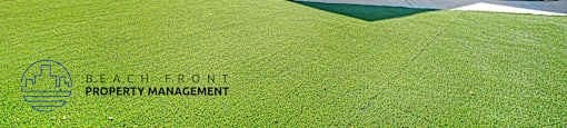 A blue house with a green lawn and a logo that says "Beach Front Property Management".