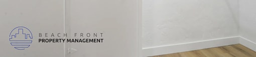 A white closet with a door and a logo for Beach Front Property Management.