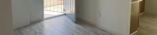 A room with a white door and a white wall.