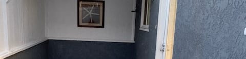 an empty room with a white floor and a door