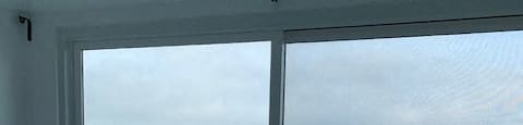 a view of the beach from a room with a glass door