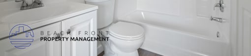 A white bathroom with a toilet, sink, and bathtub.