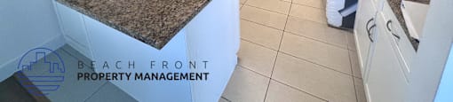 A kitchen with granite countertops and white cabinets is for sale.